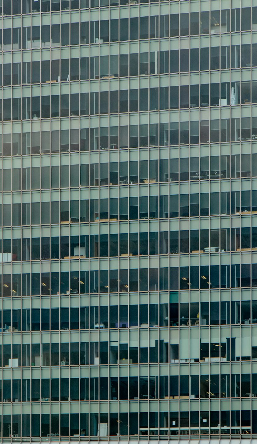 Modern office building facade with repetitive square windows.